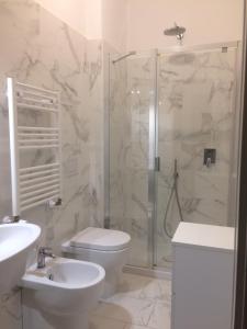 a bathroom with a shower and a toilet and a sink at SoggiorniSorrento in Sorrento