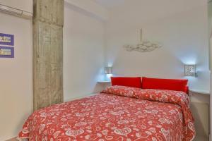 a bedroom with a red bed with red pillows at Casa di Linda in Maiori