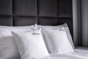 two white pillows sitting on top of a bed at Luxo apartments 13 in Jelenia Góra