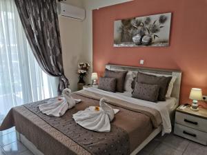 a bedroom with two swans towels on a bed at Evris House in Kavala