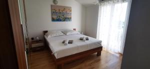 Postel nebo postele na pokoji v ubytování Apartments Marin, Kolan, Mandre, Pag