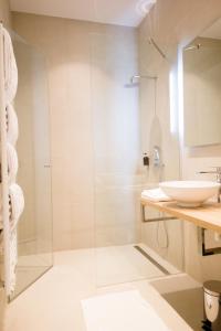 ein Bad mit einer Glasdusche und einem Waschbecken in der Unterkunft Studio Apartments Opera - Mai's Apartments - by Arbio in Wien