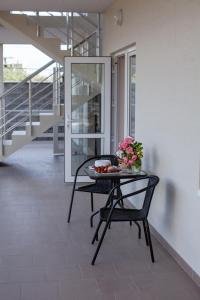 a table with a bowl of fruit and flowers on it at Estate House in Zatoka