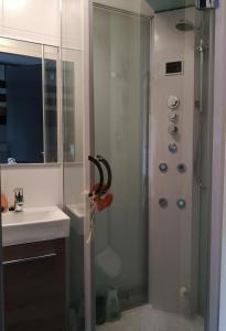 a bathroom with a shower and a sink at Ruka - Vuosselin Helmi B21 in Ruka