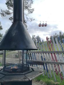 an outdoor stove with a bunch of skis in the background at Ruka - Vuosselin Helmi B21 in Ruka