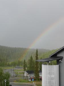 a view of a house with a rainbow in the background at Ruka - Vuosselin Helmi B21 in Ruka