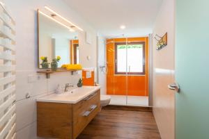 an orange door in a bathroom with a sink at Appartements und Ferienhaus Gasthof Kanzlersgrund in Oberhof +67 photos