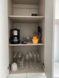 a cupboard filled with glasses and a blender at Luxury sea view MARGOAPARTMENTS in Gran Alacant