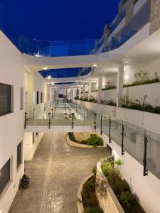 a large white building with a courtyard at night at Luxury sea view MARGOAPARTMENTS in Gran Alacant