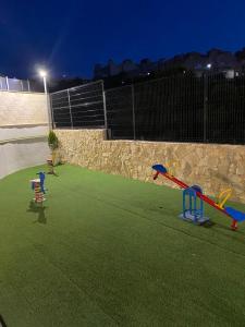 un parque infantil con equipo de juegos en la hierba en Luxury sea view MARGOAPARTMENTS, en Gran Alacant