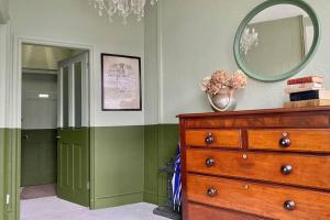 a room with a dresser and a mirror on the wall at The Court Yard in Bowness-on-Windermere
