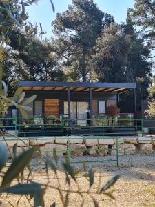 a house in a park with trees in the background at LUXURY MOBILE HOMES IVACI in Rovinj