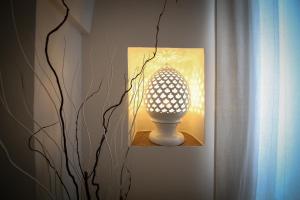 a lamp on a wall next to a plant at Loft Poerio Ostuni in Ostuni +22 photos