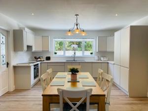 a kitchen with a table and chairs in a kitchen at The Mid Kerry Escape in Milltown