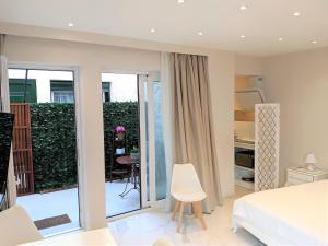 a bedroom with a bed and a balcony at Corfu Town Luxury Studios -D in Corfu Town
