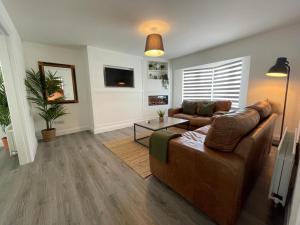 a living room with a couch and a table at The Mid Kerry Escape in Milltown