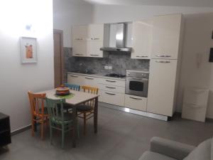 a kitchen with a table and chairs in a room at Dolce Brezza in Montesilvano