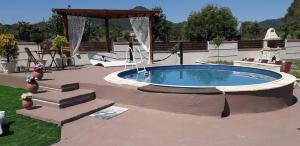 a swimming pool in a patio with a gazebo at ANTIGONH COUNTRYSIDE VILLA !i in Kokkínion