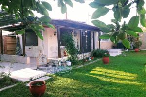 a house with a yard with green grass at Marilyn's Cottage in Sozopoli Chalkidiki in Sozopoli