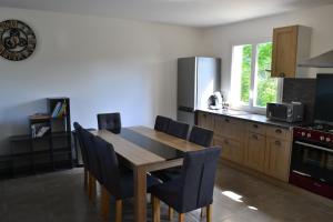 a kitchen with a dining room table and chairs at Maison Cinona in Le Mont-Dore +29 photos