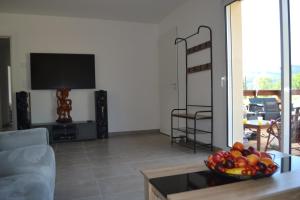 a living room with a bowl of fruit on a table at Maison Cinona in Le Mont-Dore