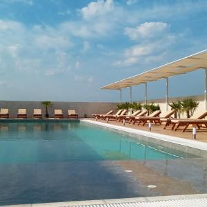 a swimming pool with lounge chairs and a swimming poolvisor at Imperial Hotel in Shënkoll