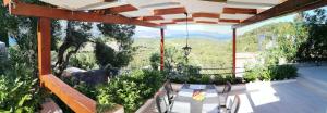 a patio with a table and chairs on a balcony at Holiday Home Korkyra Sunrise in Korčula