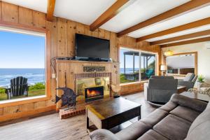 a living room with a fireplace and a television at Sea Castle BeachFront Getaway in Lincoln Beach