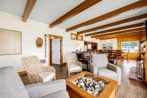 a living room with a couch and chairs and a table at Sea Castle BeachFront Getaway in Lincoln Beach