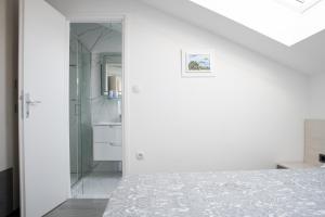 Postel nebo postele na pokoji v ubytování Apartmani Vrtodusic