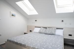 Postel nebo postele na pokoji v ubytování Apartmani Vrtodusic