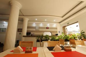 a room with a table and chairs and columns at Gran Chevalier Hotel in Sao Paulo