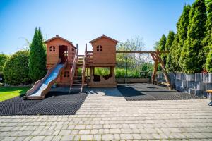 a playground with a slide and a play house at Willa Horn in Władysławowo
