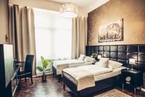 Posteľ alebo postele v izbe v ubytovaní Alfons Boutique Hotel