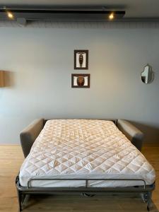 a bed in a room with two pictures on the wall at Luxury Loft Apartment Akureyri in Akureyri