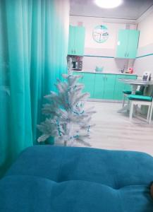 a christmas tree in a room with a kitchen at Tiffany apartment in the center in Dnipro