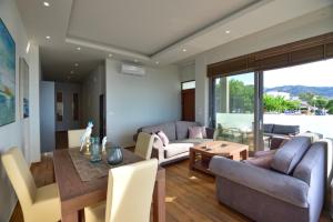 a living room with a couch and a table at Gonis Grand Luxury Suite in Palaiochora