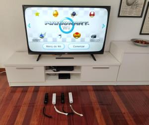 a television with a video game on the screen at Duplex de 130m2 al lado de las playas de Cuchia in Miengo