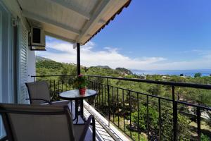 a balcony with a table and a view of the ocean at Meltemi in Parga