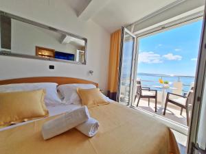 Posteľ alebo postele v izbe v ubytovaní Hotel Sunce