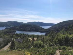 an aerial view of a lake and mountains at La Maison Harvey&Lessard in Tadoussac +11 photos