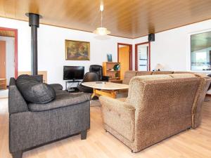 a living room with two chairs and a couch and a table at 10 person holiday home in Harboøre-By Traum in Harboør