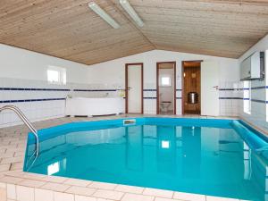 a large swimming pool with blue water in a room at 10 person holiday home in Harboøre-By Traum in Harboør