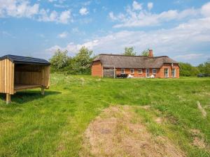a house in the middle of a field next to a building at Spacious Retreat with Spa - By Traum Ferienwohnungen in Øby