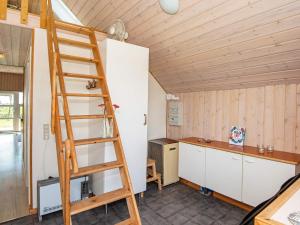 a ladder in the kitchen of a tiny house at 6 person holiday home in Harbo re in Harboør