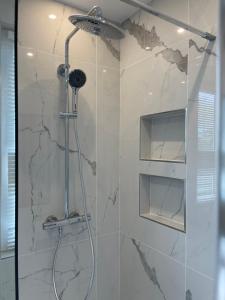 a bathroom with a shower with a glass door at Bella Mia - Chic apartment near Orly Rport 15mns frm Paris in Choisy-le-Roi