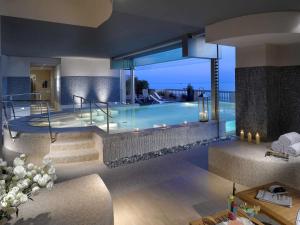 a villa with a swimming pool in a house at GH Palazzo Suite & SPA in Livorno