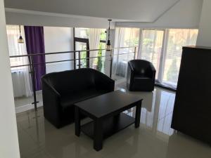 a living room with two chairs and a table at Matei Mamaia-Nord in Mamaia Sat/Năvodari +39 photos