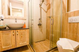 a bathroom with a shower and a sink at Kybele Suites in Kaş +48 photos