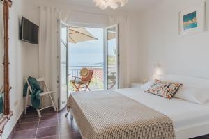 a bedroom with a bed and a view of the ocean at Anatota Hvar in Hvar
